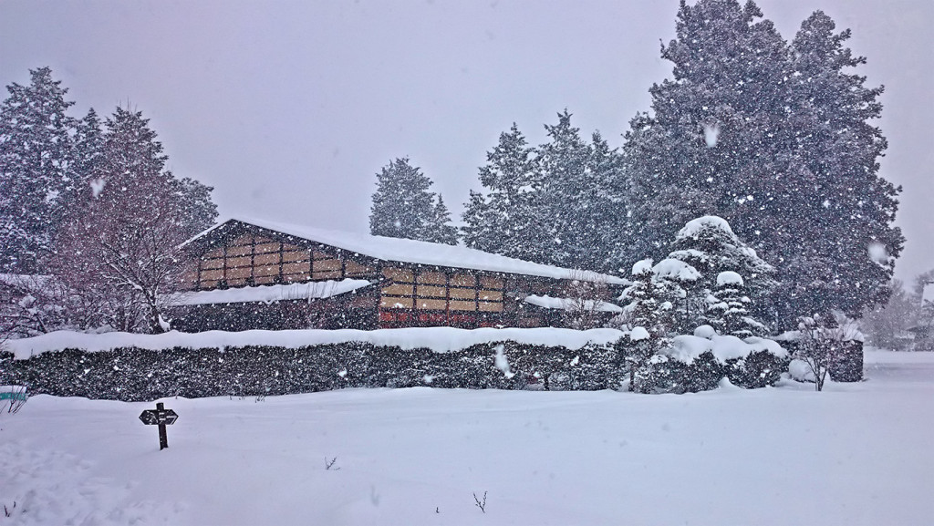 燦々と雪が降る中に佇む曽根原家住宅